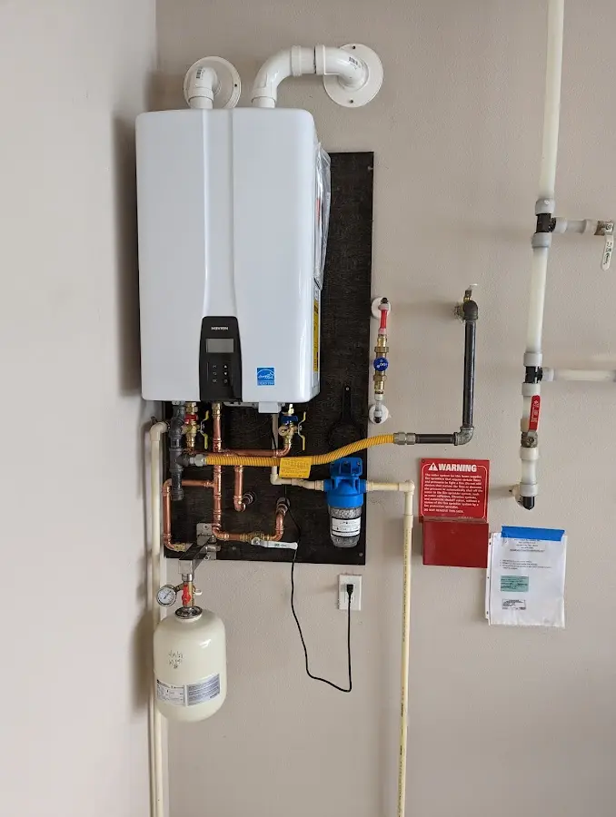 Professional plumber installing copper piping in a Hurlburt Field home